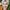 alt="Woman in white towel with foamy face mask, surrounded by citrus and herbs in a natural skincare setting"